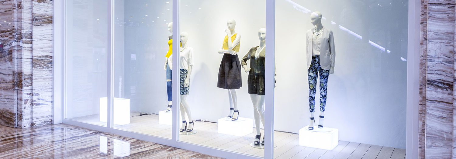 Fashion window display with installed grouping of clothing outfits