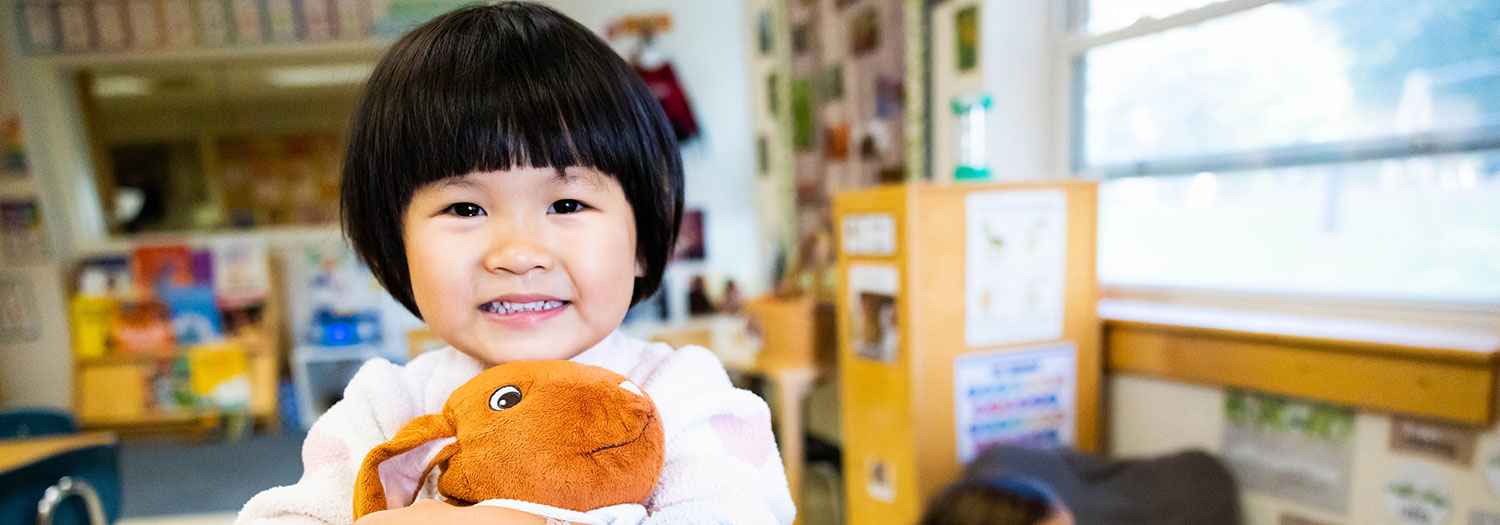 Child holding stuffed animal at the Child Development and Family Center